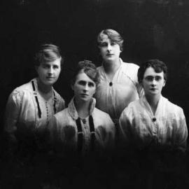 Studio group portrait of four women.
