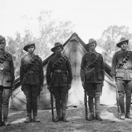 Six unidentified men in Australian Army uniforms standing in front of tents.