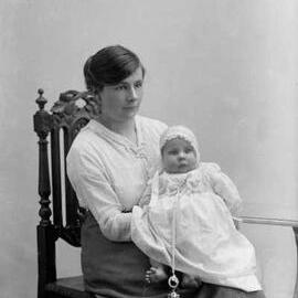 Studio portrait of a seated woman holding a baby.  Family name Pierce.