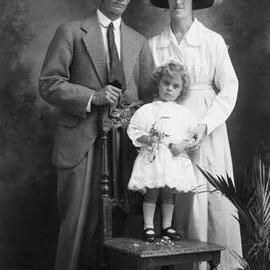 Studio portrait of a well dressed man, woman and child.  Family name Spinner.