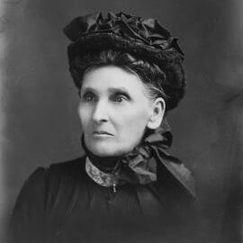 Studio portrait of an elderly woman wearing a black hat.  Family name possibly Poulter.