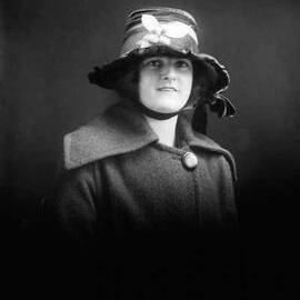 Studio portrait of Miss Williams in a fruited hat.
