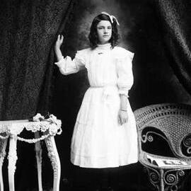 Studio portrait of a young woman in a white dress.  Family name Payne.