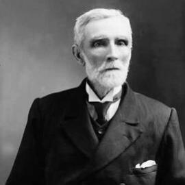 Studio portrait of an elderly white-haired man.  Family name Dunlop.