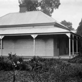 A large weatherboard house with a verandah.