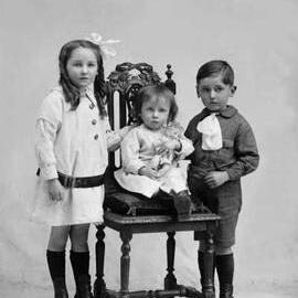 Studio portrait of three children.  Family name Mc Coy.