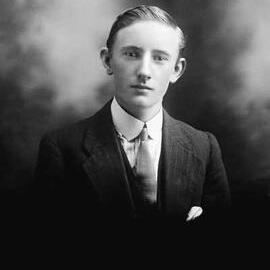 Studio portrait of a young man wearing a suit.  Family name Duffy.