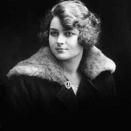 Studio portrait of Miss Samuels wearing a fur trimmed coat.