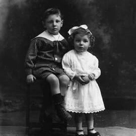 Studio portrait of a boy and a girl.  Family name Tyrrell or Tyrrill.