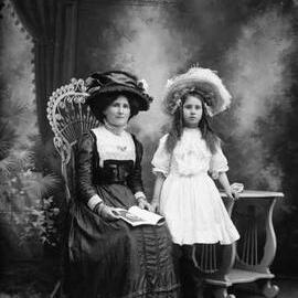 Studio portrait of a woman and a girl.  Family name Newson.