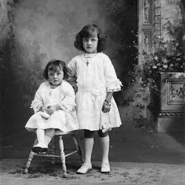 Studio portrait of two young girls.   Family name Clark.