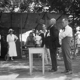 An unidentified group of people at a tennis trophy presentation.