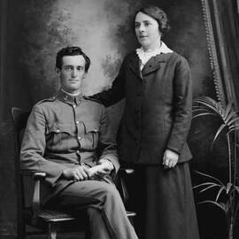 Studio portrait of a man and a woman.  Family name Farmer.