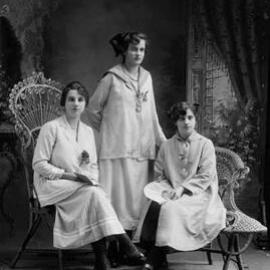Studio portrait of three well dressed young women.  Family name Harper.
