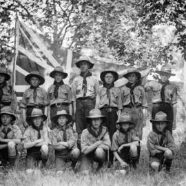 An unidentified group of Boy Scouts in front of a Union Jack.