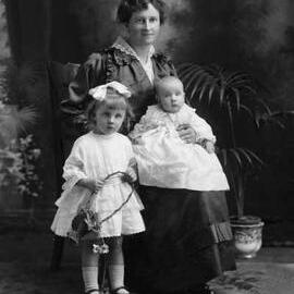 Studio portrait of Mrs. Smith with two children.