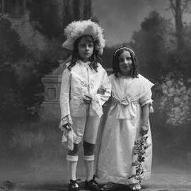 Studio portrait of a girl and a boy wearing costumes.  Family name Mc Donald.