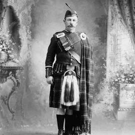 Studio portrait of Mr. Cavendish in a Scottish highland costume.