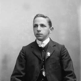 Studio portrait of a young man in a three piece suit.  Family name Wood.
