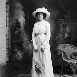 Studio portrait of Miss Meuleman [?] wearing a large hat.