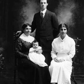 Studio group portrait of a man, two women and a baby.  Family name Reynolds.