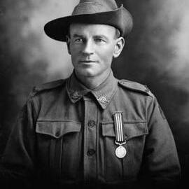 Studio portrait of Mr. Walker wearing an Australian Army uniform.