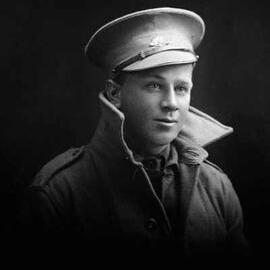 Studio portrait of a young man wearing an Australian Army uniform including a peaked cap.