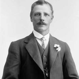 Studio portrait of a man wearing a three piece suit.  Family name Symonds.