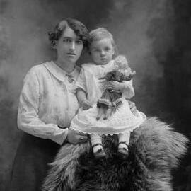 Studio portrait of Mrs. Johnson with a baby.