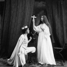 Two unidentified people in costume, photographed in a studio.