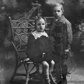 Studio portrait of a girl and a boy.  Family name Kenzell.