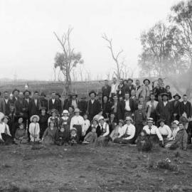 An unidentified group of people relaxing in a farmland environment.