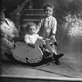 Studio portrait of young girl and boy. Family name Naughton.