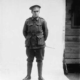 Studio portrait of Mr. Dennison wearing an Australian Army uniform.