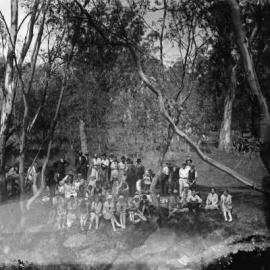 An unidentified group of people in a bushland environment.