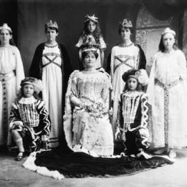 A posed mixed group of people dressed in theatrical costumes.