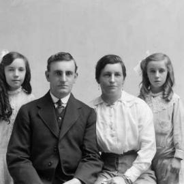 Portrait of a seated woman and man flanked by two girls.  Family name Bryce.