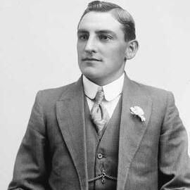 Studio portrait of a man wearing a three piece striped suit.  Family name Cardova.