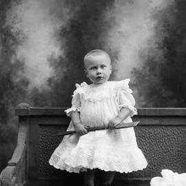 Studio portrait of a young girl with short hair.  Family name Archer.