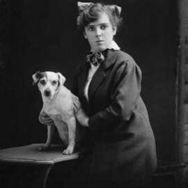 Studio portrait of a young woman and a dog.  Family name Jamieson or Jameson.