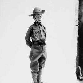 Studio portrait of a boy wearing an army cadet uniform.  Family name Chapman.