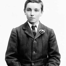 Studio portrait of a seated boy.  Family name possibly Brewer.