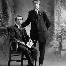 Studio portrait of two well dressed young men.  Family name Shiels.