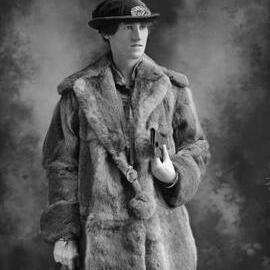 Studio portrait of Miss Kirby wearing a fur coat.