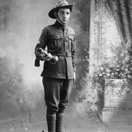 Studio portrait of a young man in an army style uniform.  Family name Edwards.