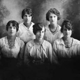Studio group portrait of five young women.