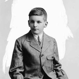 Studio portrait of a teenage boy wearing a three piece suit.  Familt name possibly Mitchell.