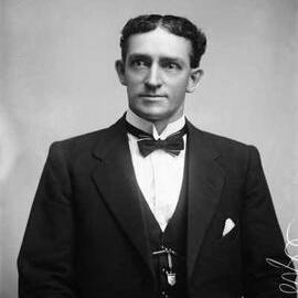 Studio portrait of Mr. Doyle wearing a suit.