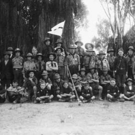 A posed group of boy scouts in a park.