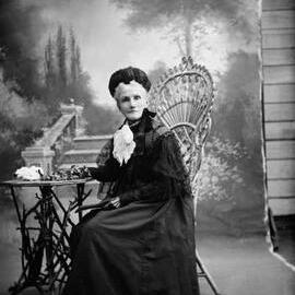 Studio portrait of a woman dressed in black.  Family name Curtis.